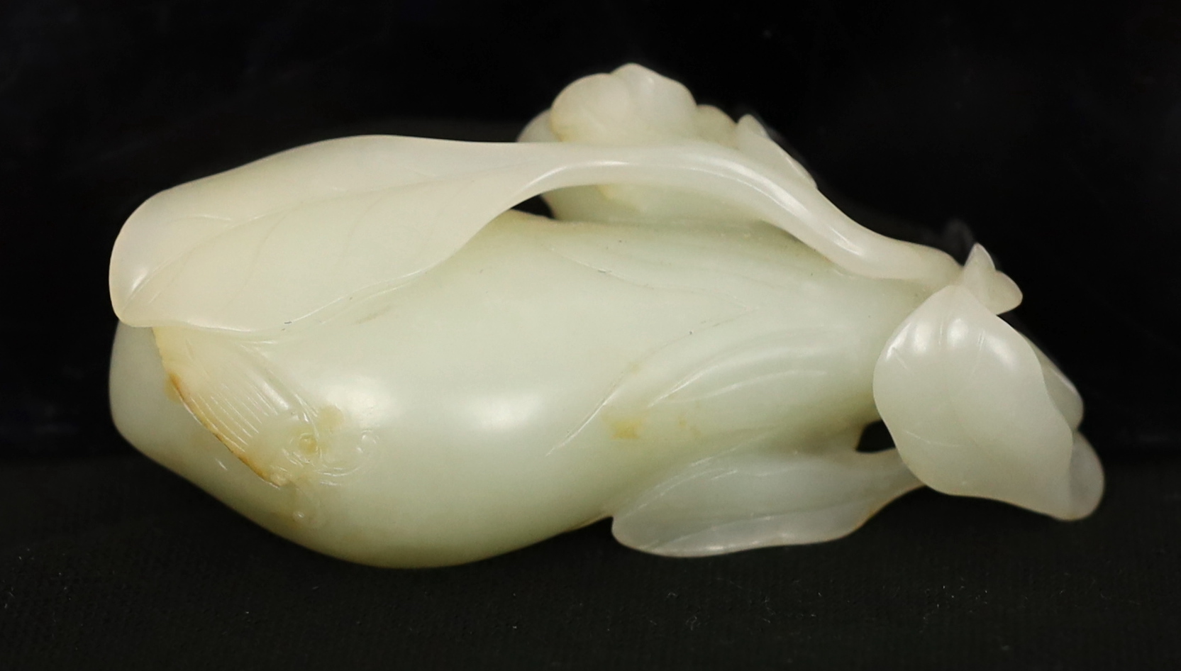 A Chinese pale celadon jade carving of a fruit, 18th century